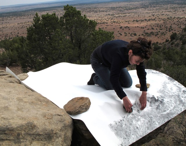 Artist Jill O'Bryan creating "frottage" drawing in the desert landscape of New Mexico.